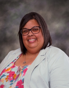 Fremont City Schools Board of Education Member Sarah Lewis in front of a colored background